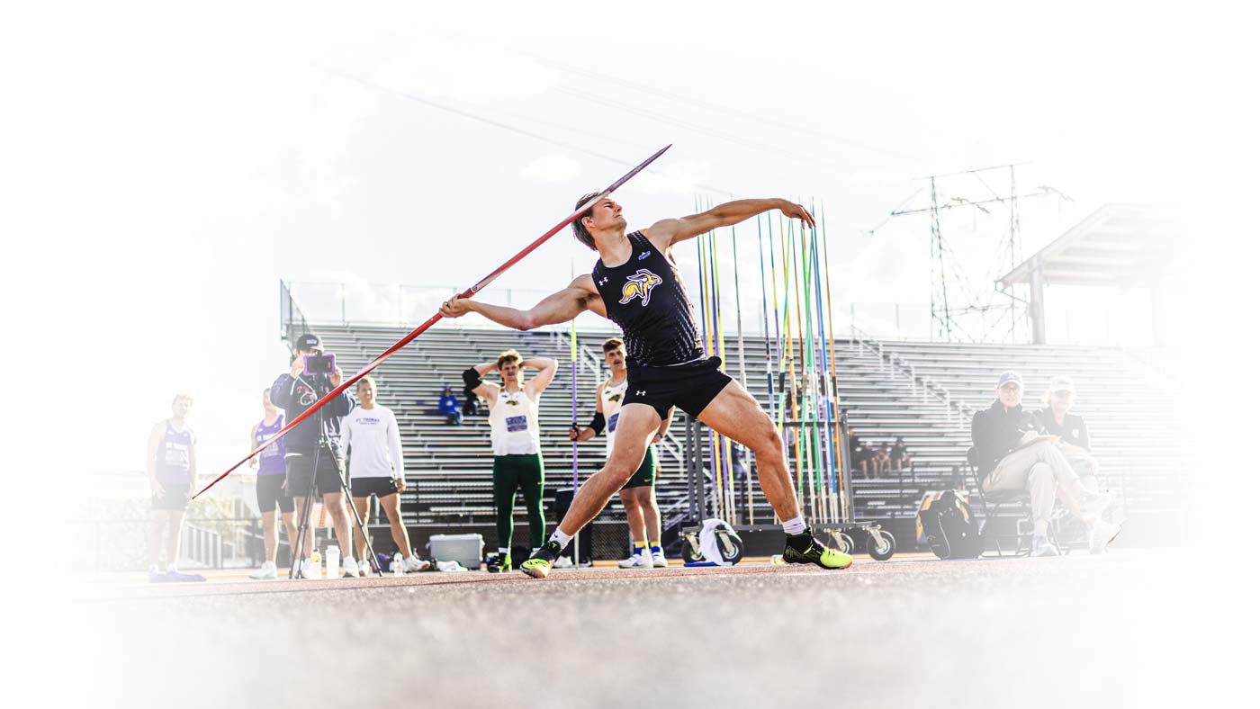 track athlete throwing javelin