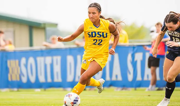 Woman dribbling soccer ball